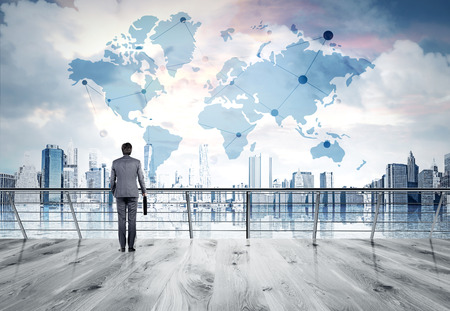 Businessman in suit standing on bridge, looking at New York city thinking about perspectives. Consept of business success. Sketch of world map at background. Elements of this image furnished by NASA. Businessman in suit standing on bridge, looking at New York city thinking about perspectives. Consept of business success. Sketch of world map at background. Elements of this image furnished by NASA.