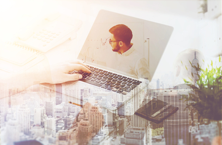 Man working at his desk. Presentation and New York City at background. Toned image. Double exposureの写真素材