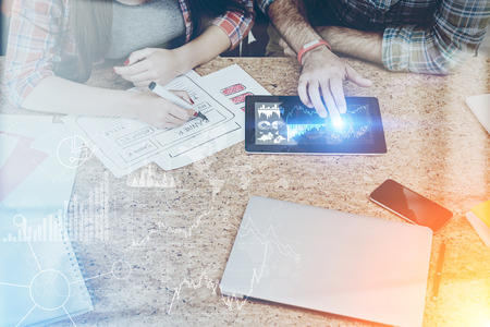 Man and woman working together developing web site. Concept of internet in business. Toned image. Double exposure.の写真素材