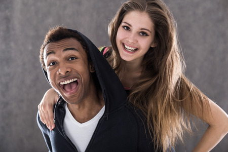 Happy African American man and his girlfriend smiling to camera. Concept of sports and joyの写真素材
