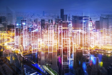 Magnificent large city panorama at night with skyscrapers and orange light. Concept of living in a megapolis. Toned image. Double exposureの写真素材