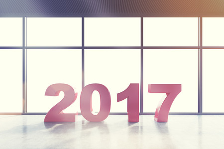Red number 2017 standing in an empty room with panoramic windows and concrete floor. Concept of the...