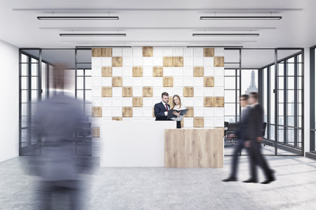 People in the office lobby. Large wall is decorated with white and wooden tiles. There is a wooden part of it and two conference rooms by both sides. 3d rendering. Mock upの写真素材