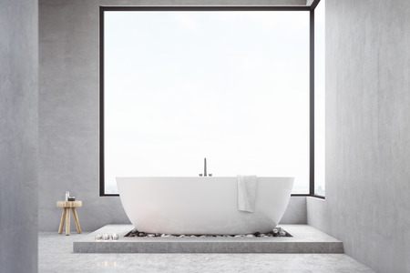 Bathroom interior with large square window, bathtub and a small chair with self care products....