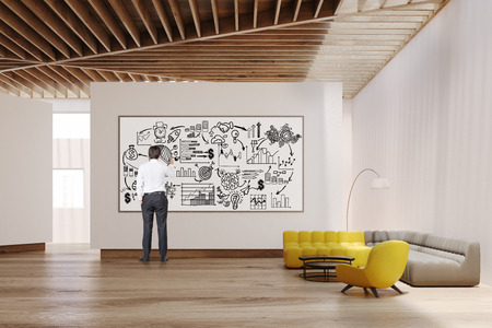 White living room interior with yellow and gray sofas, white walls, large panoramic window and a whiteboard. Man is drawing a poster on it. 3d rendering. Mock up.の写真素材