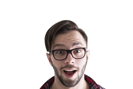 Close up portrait of a surprised happy young businessman in glasses and a red checkered shirt. He is...