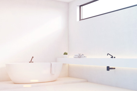 Corner of a luxury bathroom interior with white walls. There is a sink in the corner and a narrow horizontal window. 3d rendering, mock up, toned imageの写真素材