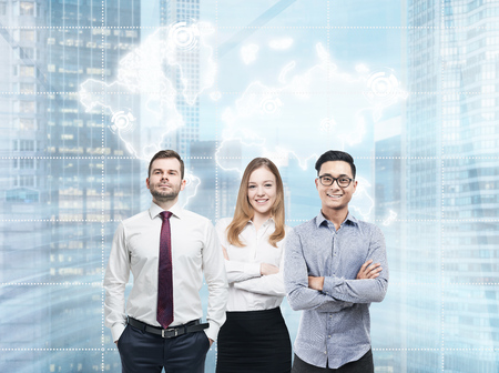 Portrait of two businessmen and a businesswoman in a city. There is a world map above their heads. Elements of this image furnished by NASAの写真素材