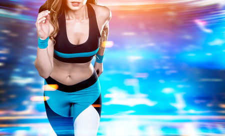 Close up of woman jogger in a black, blue and white sportswear against a virfual reality background....