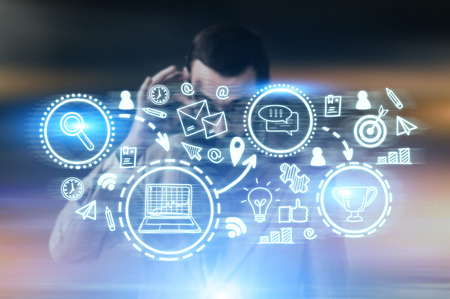 Portrait of a young bearded businessman drawing a trophy sketch on a glassboard. Blurred background.の写真素材