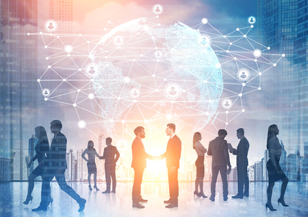 Businesspeople silhouettes are seen against a network sketch and the Earth hologram in the sky. Toned image, double exposure.の写真素材