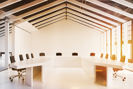 Close up of a house framed conference room with a white floor and walls and three tables with chairs around them. 3d rendering, toned image.の写真素材