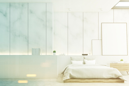 Front view of a bedroom with marble walls, a double bed and two blank posters to the right of it. Large wall fragment to the left. 3d rendering, mock up, toned imageの写真素材