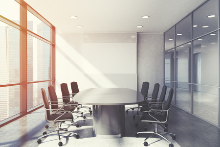 Front view of a white conference room interior with a long table and two rows of black office chairs by its sides. Horizontal poster. 3d rendering, mock up, toned imageの写真素材