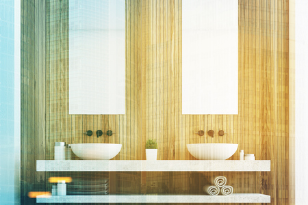 Wooden bathroom with a light wall, two white sinks and two tall rectangular mirrors hanging above them. 3d rendering toned imageの写真素材