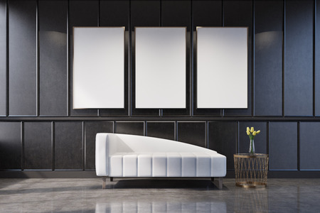 Gray living room interior with a poster gallery on the wall. There is a white couch and a coffee...