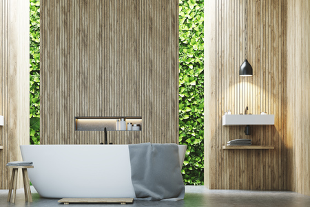 Eco bathroom interior with narrow windows, green shrubbery is seen through them. There is a sink...