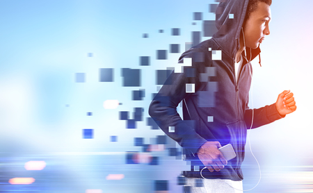 Side view of a running African American young man against a blurred cityscape background. Polygons. Pixilated. Toned image mock up double exposure.の写真素材