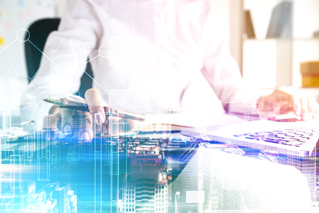 Close up of an unrecognizable businesswoman typing on a keyboard while sitting in an office. Blue cityscape and graphs. Toned image double exposure mock up.のeditorial素材