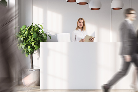 Close up of people near a white reception counter is standing in an office with white walls, wooden floor, potted trees and a door. 3d rendering mock upの写真素材