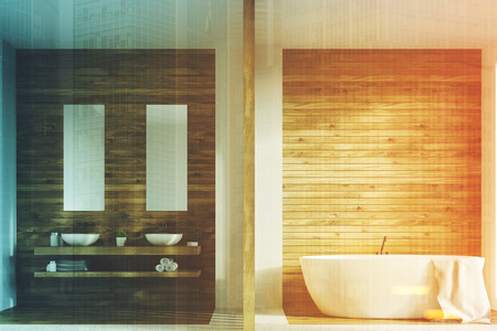 Wooden bathroom interior with a tub, two white sinks standing on a wooden shelf. There are two narrow vertical posters above them. 3d rendering mock up toned imageの写真素材