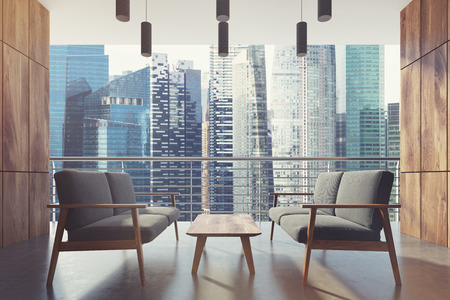 Wooden balcony with gray armchairsの写真素材