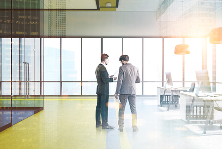 Yellow open office interior with a row of wooden tables, computers on them, panoramic windows and a conference room. People. Round lamps. 3d rendering mock up toned image double exposureの写真素材