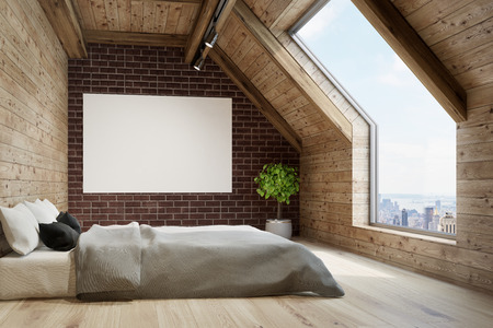 Side view of a bedroom in the attic with wooden walls and floor, a large window in the roof, a bed with a gray cover and a horizontal poster. 3d rendering mock upの写真素材