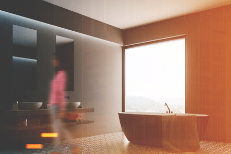 Woman in a gray bathroom interior with a tiled floor, a double sink and a door to the yard. Corner. 3d rendering mock up toned imageの写真素材