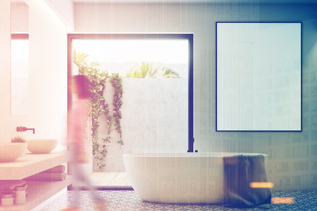 Woman in a white bathroom interior with a tiled floor, a double sink, a framed vertical poster and a door to the yard with a plant on the wall. 3d rendering mock up toned imageの写真素材