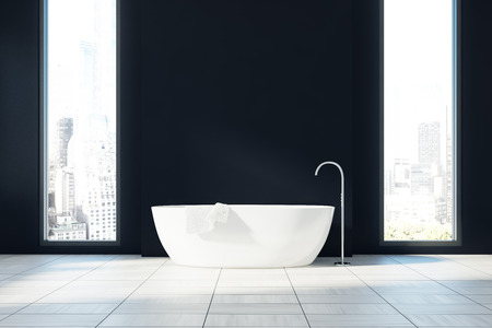 Black minimalistic bathroom interior with a white floor, two narrow and tall windows with a cityscape and a white tub. 3d rendering mock upの写真素材