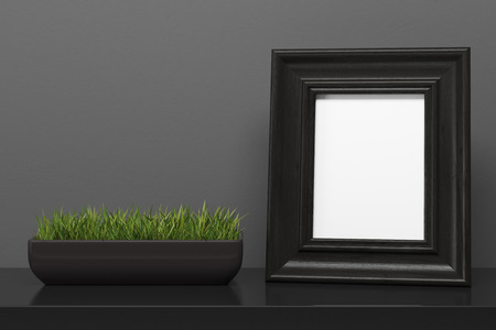 Black photo frame and a potted plant are standing on a black wooden table near an open copybook with a pencil on it. 3d rendering mock upの写真素材