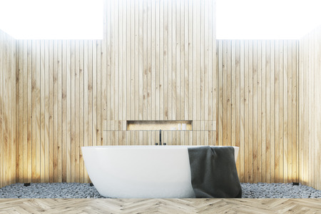 Close up of a wooden bathroom with a white tub, a black towel hanging on it and a wooden and rubble floor. 3d rendering mock upの写真素材
