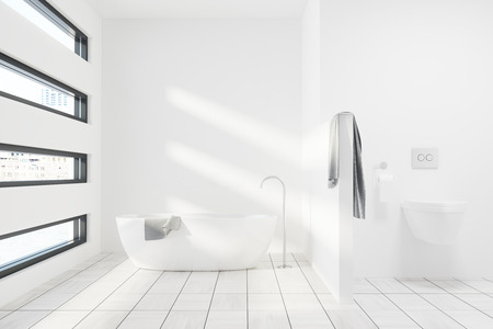 Luxury white bathroom interior with a white tub, a toilet, a gray towel and an originally shaped window. 3d rendering mock upの写真素材