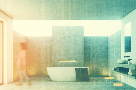 Concrete bathroom with a white tub, a black towel hanging on it and a concrete and rubble floor. Woman. 3d rendering mock up toned image double exposureの写真素材