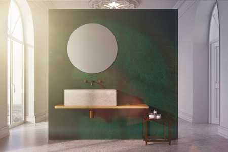 Green and white bathroom interior with a concrete floor, many windows, a round mirror, an angular sink near a green wall and a table with self care products. 3d rendering mock up toned imageの写真素材