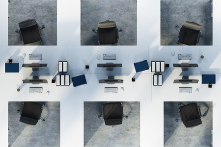 Top view of two rows of white table office cubicles with computers and folders on the desks. A concrete floor. Concept of a start up. 3d rendering mock upの写真素材