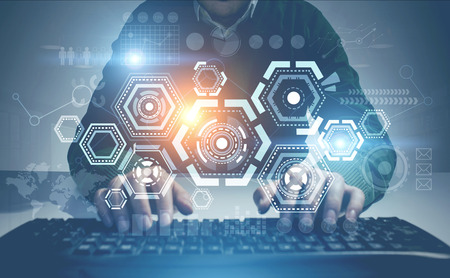 Unrecognizable man in a green sweater typing in a room. HUD and infographics. Toned image double...