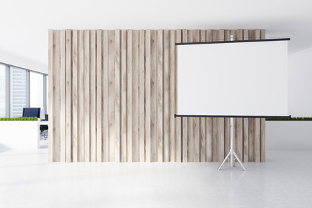A white screen is standing next to a wooden wall in an open space office environment with large windows. 3d rendering mock upの写真素材