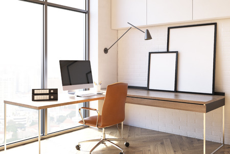 Loft home office interior with white walls, two desks, a computer and two empty blank pictures. Side view. 3d rendering mock upの写真素材