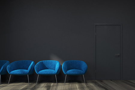 Black waiting area with dark gray walls, a wooden floor and a row of soft blue armchairs. 3d rendering mock upの写真素材