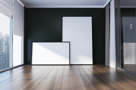 Empty room interior with black walls, a wooden floor, panoramic windows and two framed posters. 3d rendering mock upの写真素材
