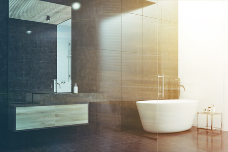 Black and white bathroom corner with a tiled floor, a white tub, and a sink with a large mirror. 3d rendering mock up double exposure toned imageの写真素材