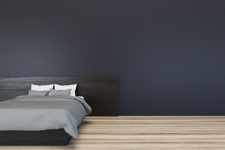 Minimalistic bedroom interior with black walls and a gray master bed on a wooden floor. 3d rendering mock upの写真素材