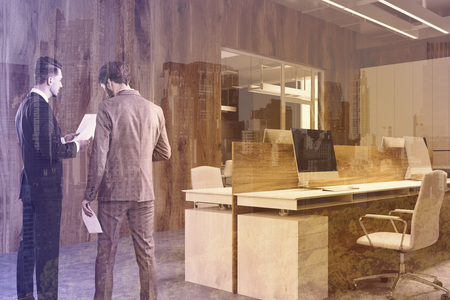 Wooden wall office with a concrete floor, gray computer tables and a white bookcase near a loft window. Business people 3d rendering mock up toned image double exposureの写真素材