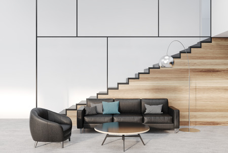 White and wooden living room interior with a black sofa and armchair and a wooden staircase. 3d...