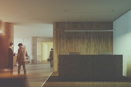 Loft white and wood wall office interior with a gray and wooden reception desk and a column. An open space area background. A close up. Business people 3d rendering mock up toned image double exposureの写真素材