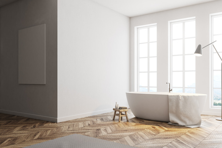 Minimalistic bathroom corner with tall windows, white walls, a wooden floor and a white bathtub. A poster on the wall. 3d rendering mock upの写真素材