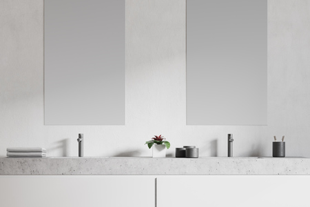 Modern double sink in a white wall bathroom interior with a large horizontal mirror and creams. A close up. 3d rendering mock upの写真素材