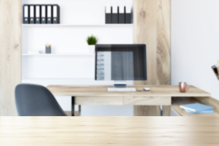 Company office with a wooden bookcase and a computer table with a black chair. Folders on the shelves. 3d rendering mock up blurredの写真素材
